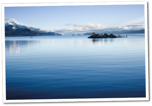 The tranquility of Lake Victoria in Bariloche, Argentina, is reflected in the blue water 