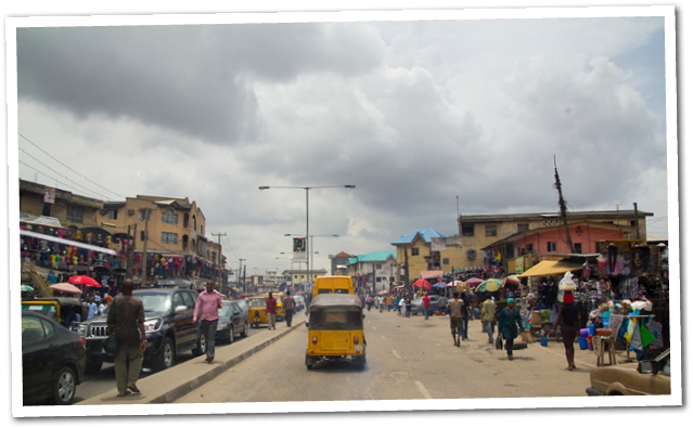 Lagos, Nigeria - May 11, 2012: People and cars in the street, in the city of Lagos, the largest city in Nigeria and the African continent  Lagos is one of the fastest growing cities in the world