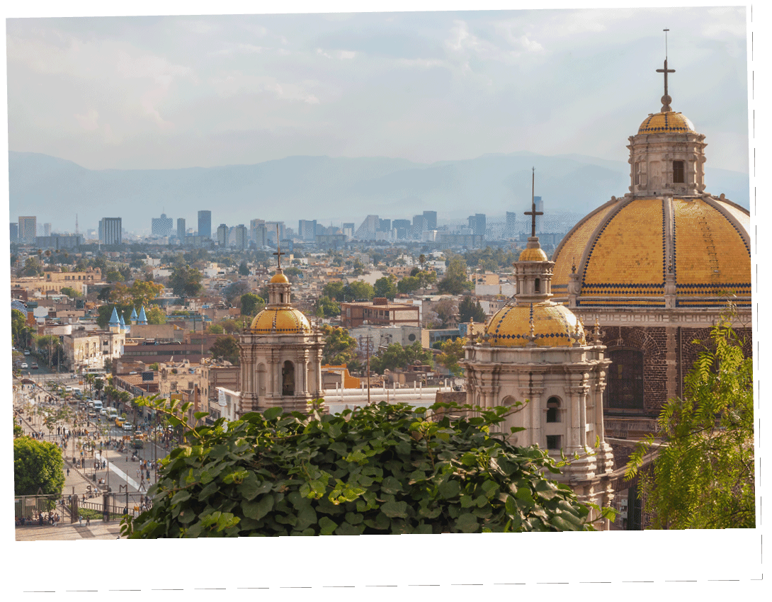 Old Basilica of Guadalupe with Mexico City skyline behind it